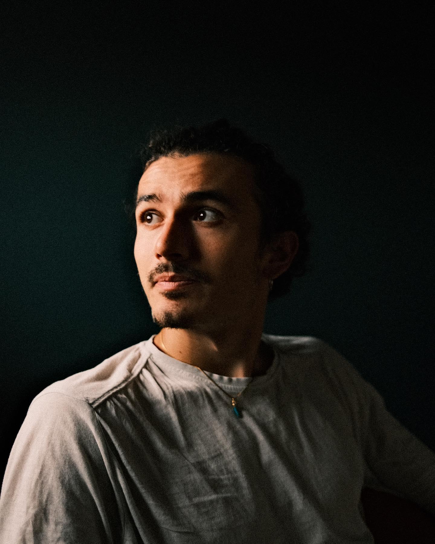 Matteo Maringola in a dark studio portrait